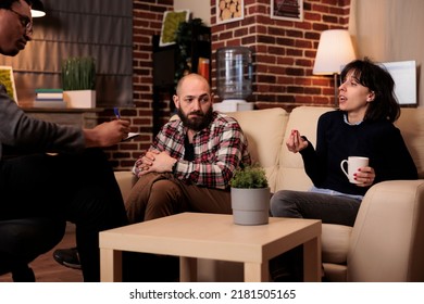 Unhappy Partners With Marriage Difficulties Talking To Psychologist At Therapy Session, Receiving Psychoanalysis Counseling To Solve Relationship Issues. Fighting And Trying To Fix Problems.