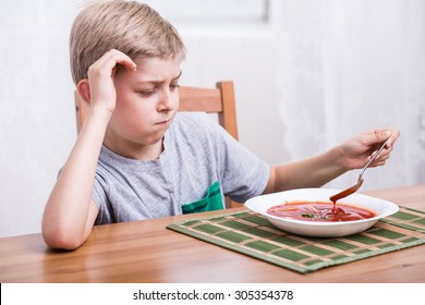 Unhappy Picky Child Eating Creamy Tomato Soup