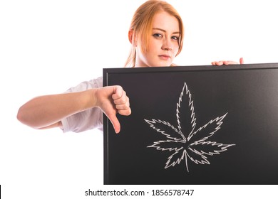 Unhappy Red Hair Woman Holding Blackboard With Cannabis Leaf Sign On It And Showing Thumbs Down. Isolated On White Background