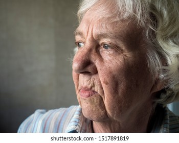 Unhappy sad elderly woman close-up portrait