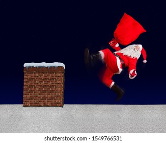 The Unhappy Santa Claus Slipped With Bag On A Snowy Roof With The Chimney. Santa Claus Accident While Distributing A Gift. The Christmas Disaster On A Roof. 