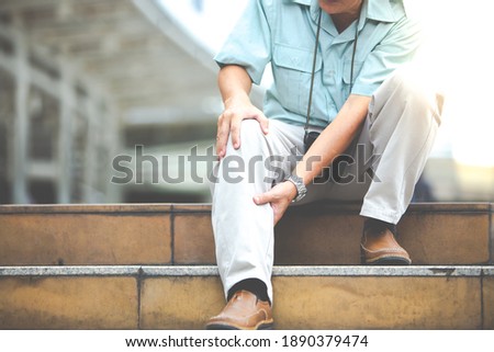 unhappy senior man suffering from knee ache. Travel and tourism concept.health problem and people concept. 