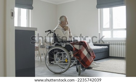 Similar – Senior woman in wheelchair alone in room