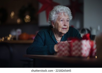 Unhappy senior woman sitting alone and waiting for family during Christmas Eve.Concept of solitude senior and mental health. - Powered by Shutterstock