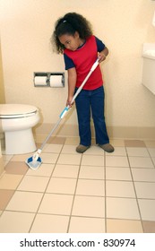 Unhappy Seven Year Child Cleaning Bathroom Floor.