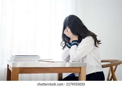 Unhappy Stress Asian Girl In Japanese Student Uniform With Tablet On Table In Classroom 