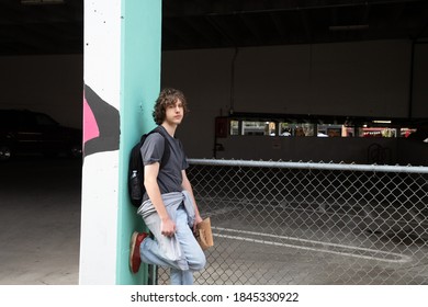 Unhappy Teen Hanging Out In A City Alley By A Parking Garage.