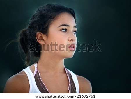 An unhappy teenage asian girl looking sideways