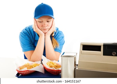Unhappy teenage girl has a boring job serving fast food.  Isolated on white.  