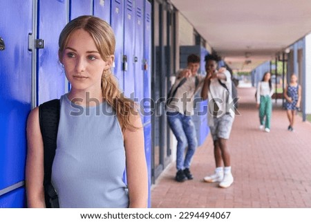 Unhappy Teenage Girl Outdoors At High School Being Teased Or Bullied