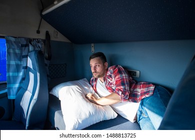 Unhappy Truck Driver Waking Up In His Vehicle Cabin Feeling Lost, Tired And Depressed For His Way Of Life. Missing Family And Sleep Deprivation. Trucker Lifestyle.