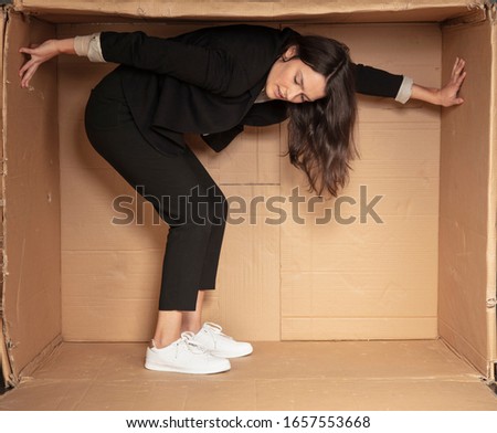 unhappy unemployed business woman trying to increase her cramped office