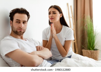 Unhappy Wife Pleading Offended Indifferent Husband For Forgiveness After Infidelity In Bedroom At Home. Woman Begging Man Not To Breakup. Marriage And Relationship Problems. Selective Focus
