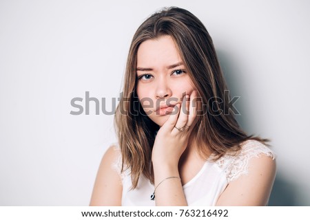 unhappy woman feel pain on her teeth isolated on white background,
