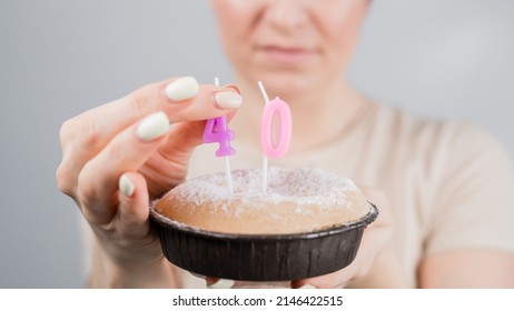 Unhappy Woman Holding A Cake With Candles For Her 40th Birthday. The Girl Cries About The Loss Of Youth.