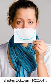 Unhappy Woman Is Holding Paper With Drawn Smile