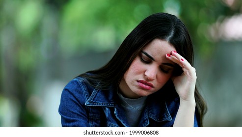 Unhappy Woman Outside At Park Regretting Decision.