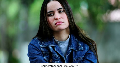 Unhappy Woman Outside At Park Regretting Decision.