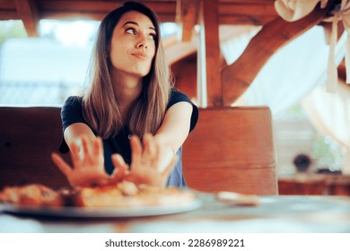 
					Unhappy Woman refusing to Eat her Pizza Dish in a Restaurant. Disgruntled customer not liking the meal sending it back
					