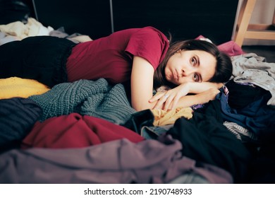 
Unhappy Woman Sitting On The Floor On A Pile Of Clothes
Girl Having Buyer Remorse From Her Fast Fashion Shopping Addiction
