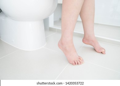 Unhappy Woman Sitting On Toilet Bowl. Concept Of Constipation, Diarrhea, Hemorrhoid, Food Poisoning Or IBS. Digestive And Gastrointestinal Problem. Close Up.