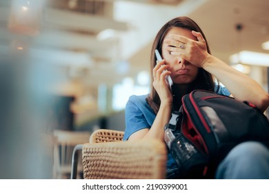Unhappy Woman Talking on the Phone Waiting in an Airport 
Stressed traveler speaking on her cellphone feeling overwhelmed - Shutterstock ID 2190399001