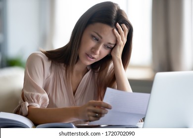 Unhappy Woman Touching Forehead And Holding Paper, Reading Bad Negative News In Letter, Upset Young Female Shocked By Unexpected Loan Debt, Bank Or Job Dismissal Notification, Eviction Notice