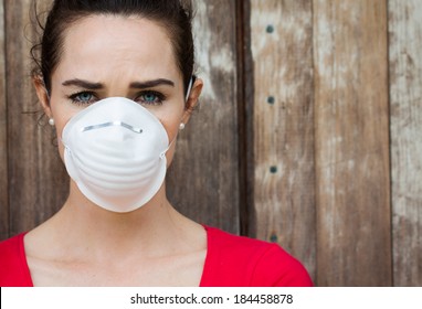 An Unhappy Woman Wearing A Face Mask To Deal With Virus Or Pollution.