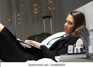 Unhappy Worker Working Online And Looking At Camera Late Hours In The Night In An Hotel Room