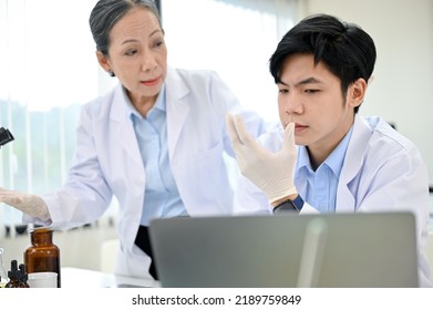 Unhappy Young Asian Male Scientist Or Medical Technician Unsatisfied With His Medical Experiment Result. Medical Development Concept.