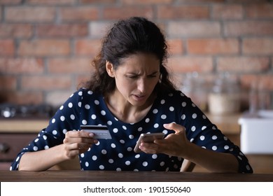 Unhappy young Caucasian female buyer have problems buying online on internet on smartphone with credit card. Angry frustrated woman confused with account money loss shopping on web on cellphone.