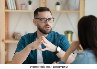 Unhappy young Caucasian man worker talk with female colleague thinking doubting at office meeting. Frustrated confused male employee brainstorm with coworker, solve problem at briefing.