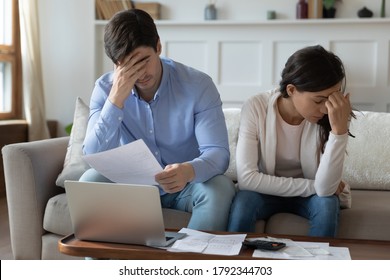 Unhappy Young Family Couple Feeling Stressed About Banking Debt Or Eviction Notification. Depressed Husband And Wife Having Financial Problems While Managing Monthly Budget, Bankruptcy Concept.