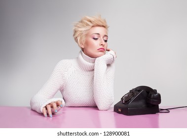 unhappy young girl waiting for phone ring despairingly