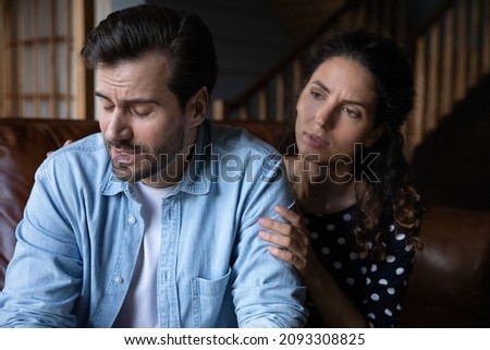 Unhappy young hispanic woman apologizing to stressed husband feeling guilty after quarrel or misunderstanding. Confused millennial man feeling offended, married couple having relations problems.