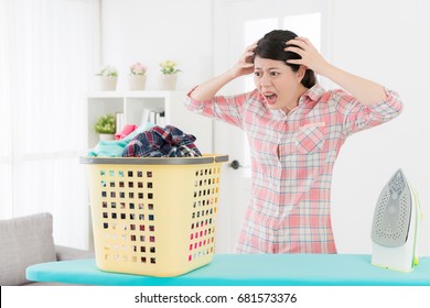 Unhappy Young Housewife Finding She Having Many Messy Family Clothing Must Be Ironing Feeling Collapse And Looking At Clothes Showing Shocked Emotional.