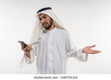 Unhappy Young Man In A Turban Using A Mobile Phone Disappointed Looking At The Screen