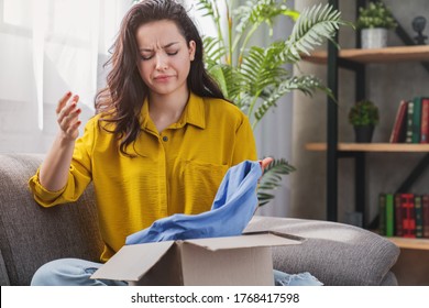 Unhappy Young Mixed Race Girl With Cardboard Box Dissatisfied With Wrong Item Delivery