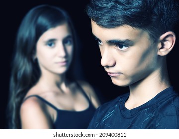 Unhappy Young Teen Couple - Boy And Girl - On A Black Background