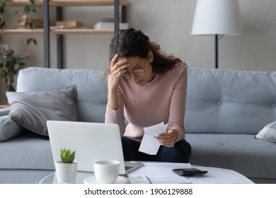 Unhappy young woman in glasses feeling stressed calculating monthly expenses at home, facing financial problems or lack of money for utility household or rental payments, bankruptcy concept.