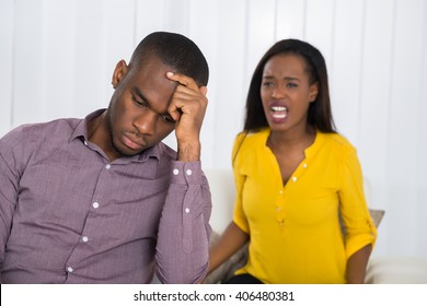 Unhappy Young Woman Having Argument With Man At Home