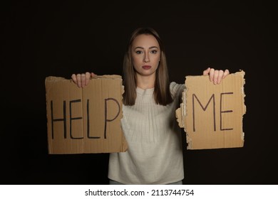 Unhappy Young Woman With HELP ME Sign On Dark Background