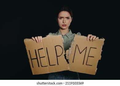 Unhappy Young Woman With HELP ME Sign On Dark Background