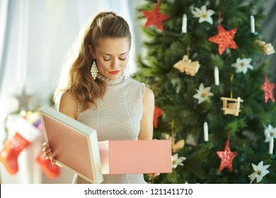 unhappy young woman with opened Christmas present box near Christmas tree - Powered by Shutterstock