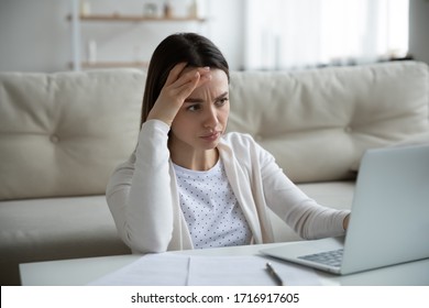 Unhappy Young Woman Sit At Home Work On Laptop Frustrated By Slow Internet Connection On Gadget, Upset Distressed Female Have Operational Computer Problems, Stressed By Unpleasant Email Or Message