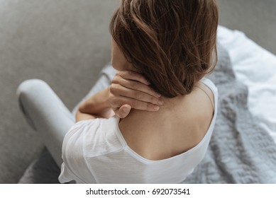 Unhappy Young Woman Suffering From Pain In The Neck