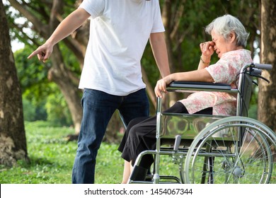 Unhappy,problems Asian Family,angry Man Or Male Caregiver Expelled His Elderly Woman In Wheelchair Quarrel,arguing,senior Mother Crying In Outdoor,aggressive Son,family,violence,ungrateful Concept