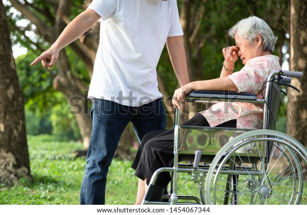 Unhappy,problems asian family,angry man or male\
caregiver expelled his elderly woman in wheelchair\
quarrel,arguing,senior mother crying in outdoor,aggressive\
son,family,violence,ungrateful\
concept