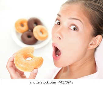 Unhealthy Diet. Surprised Woman Caught Eating Donuts Fast Food.