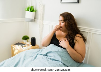 Unhealthy Fat Woman With A Bad Cold Coughing And Feeling Sick While Resting In Her Bedroom